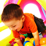 Boy Playing In The Ball-Pool